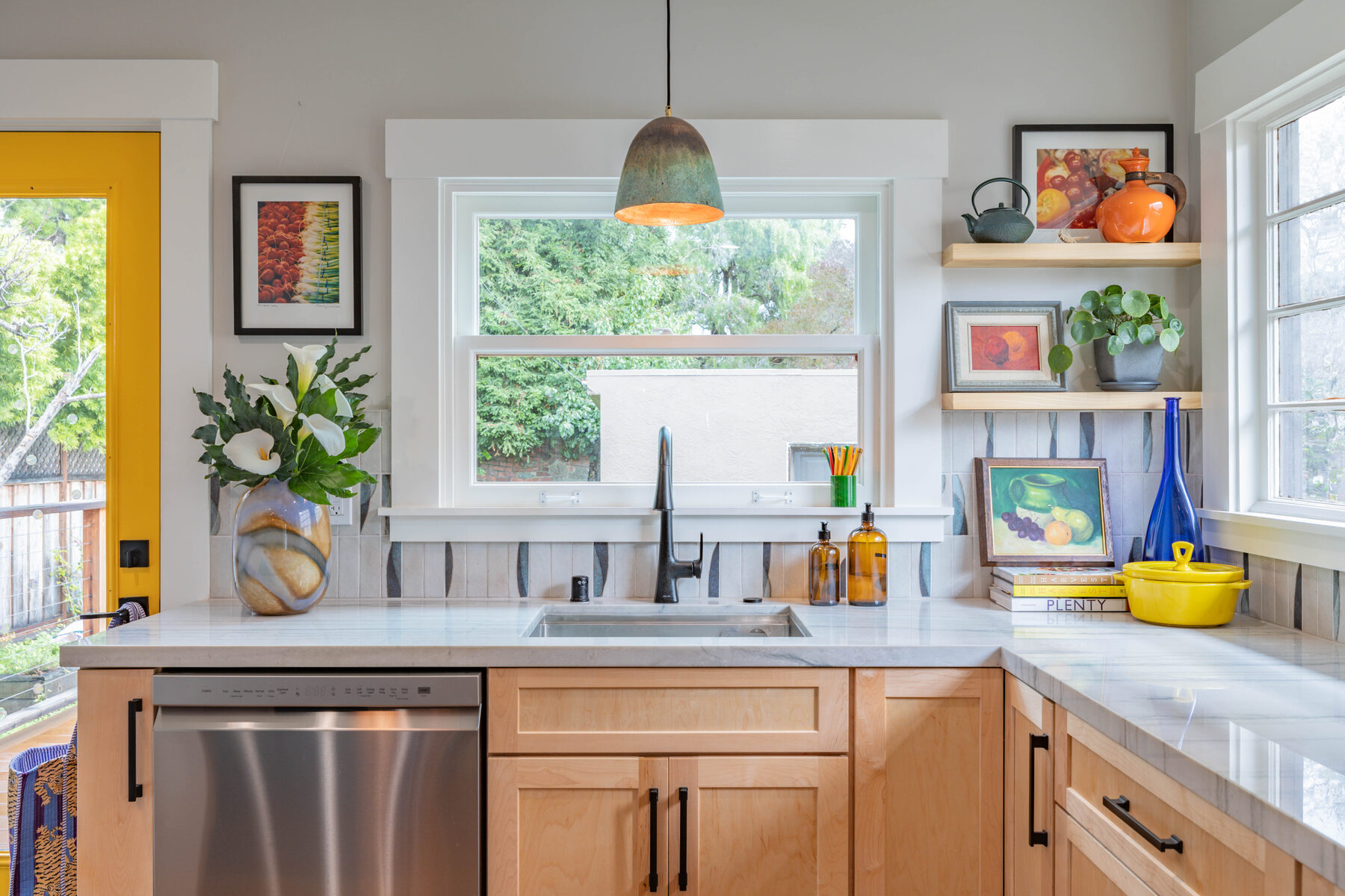 Sink wide view with vase, art, and ceramic pendant