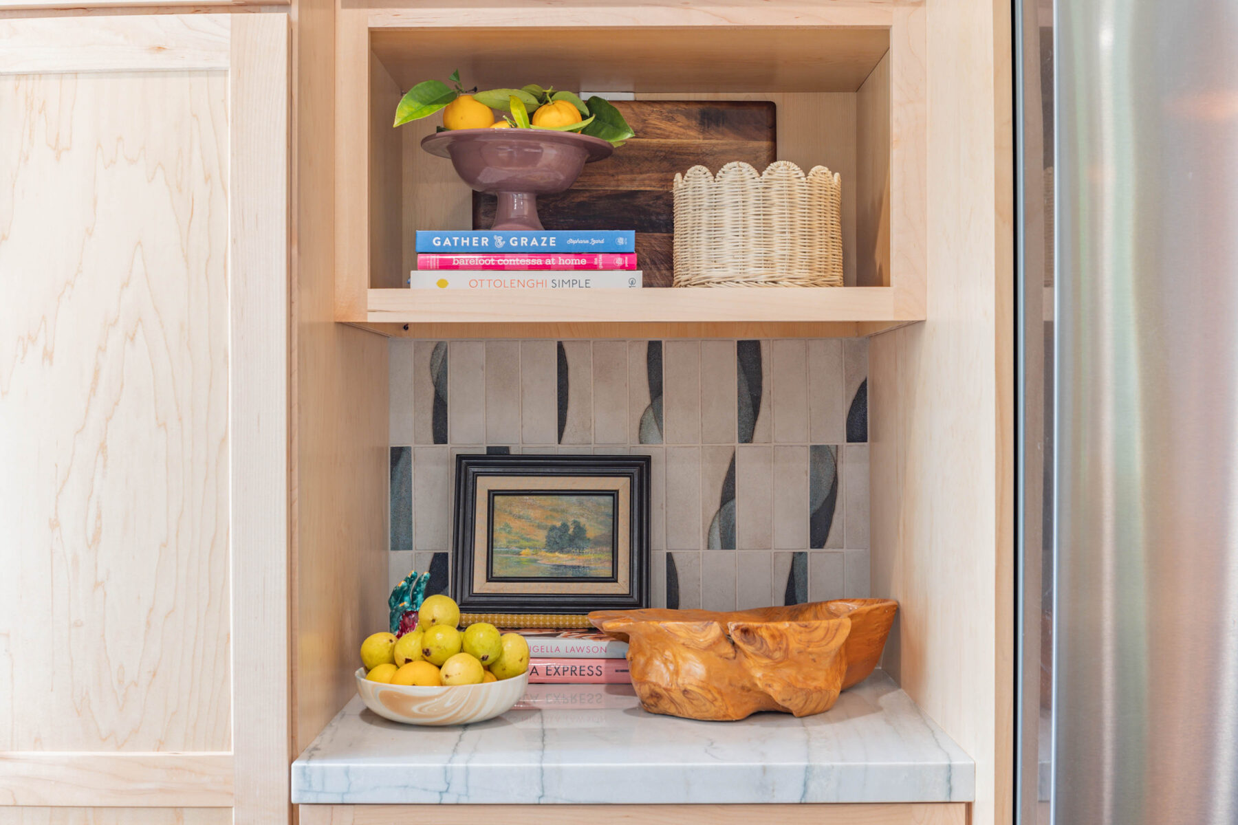 Built-in nook with cookbooks and small painting