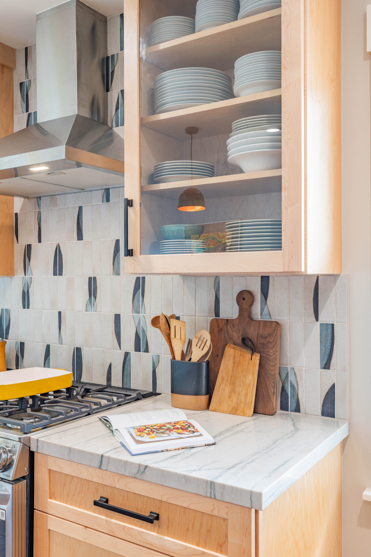 Open maple shelves with white dishes