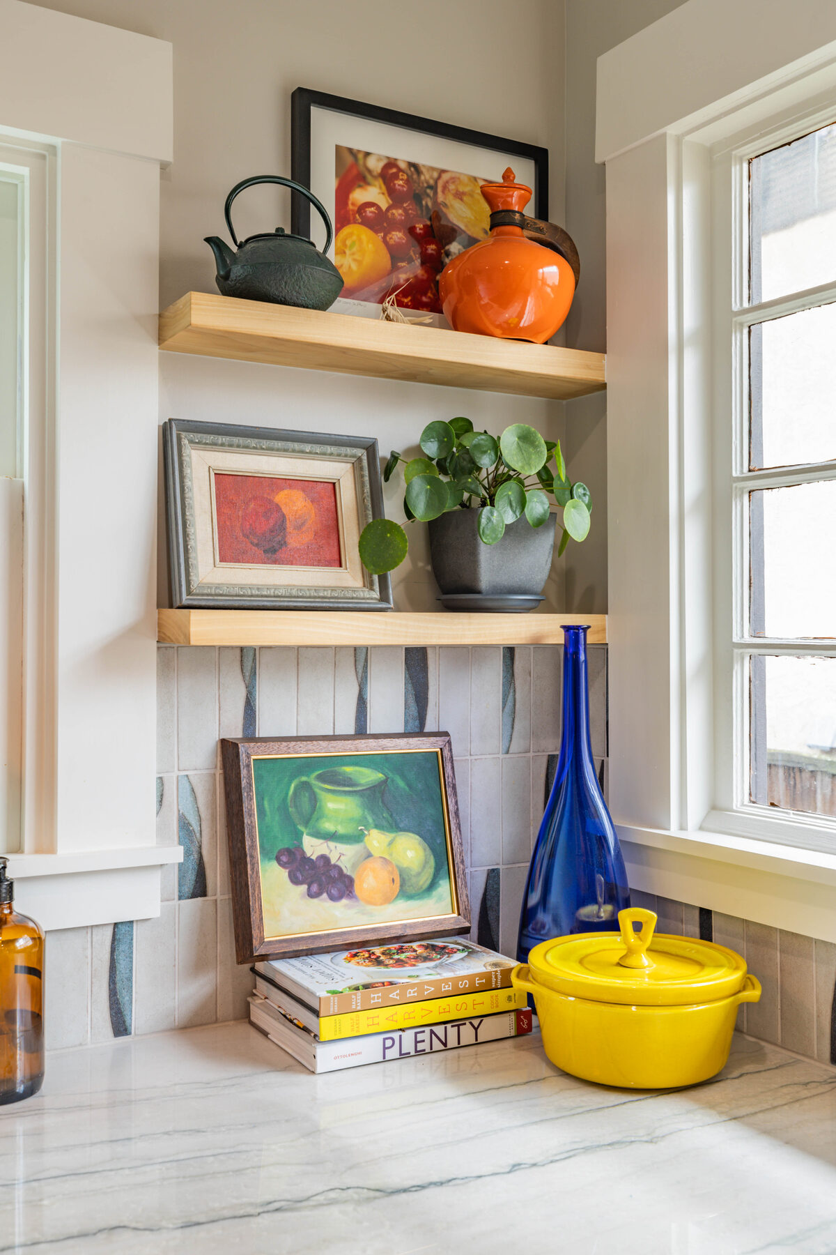 Corner shelf vignette with blue bottle and yellow Dutch oven