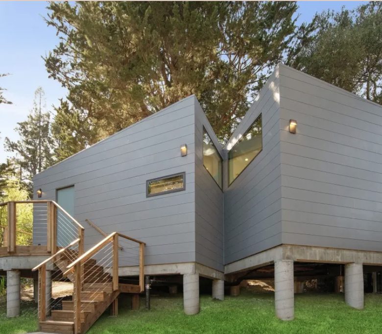 Hillside modern accessory dwelling unit on concrete piers with cedar-clad stair