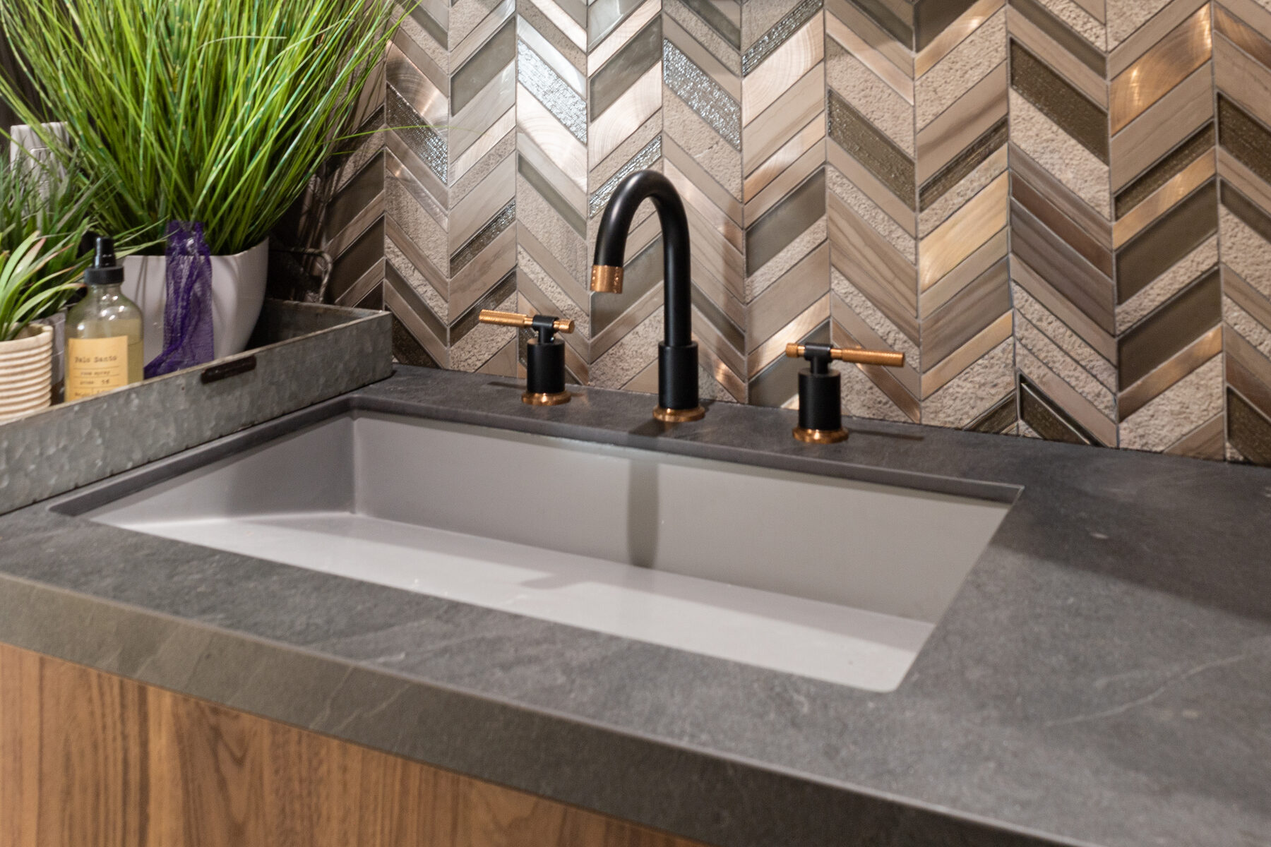 Chevron tile and brass faucet detail