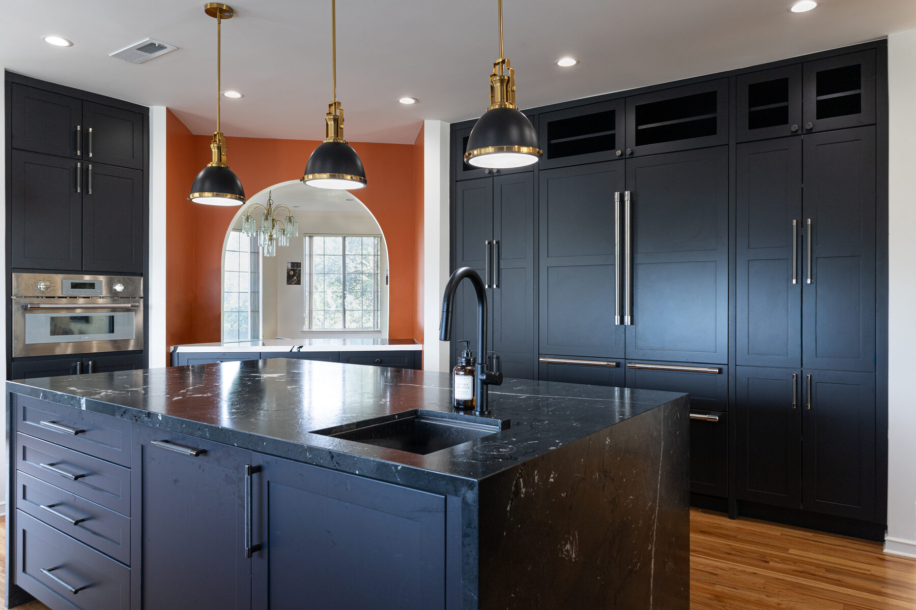 Campus Drive navy kitchen with burnt orange archway