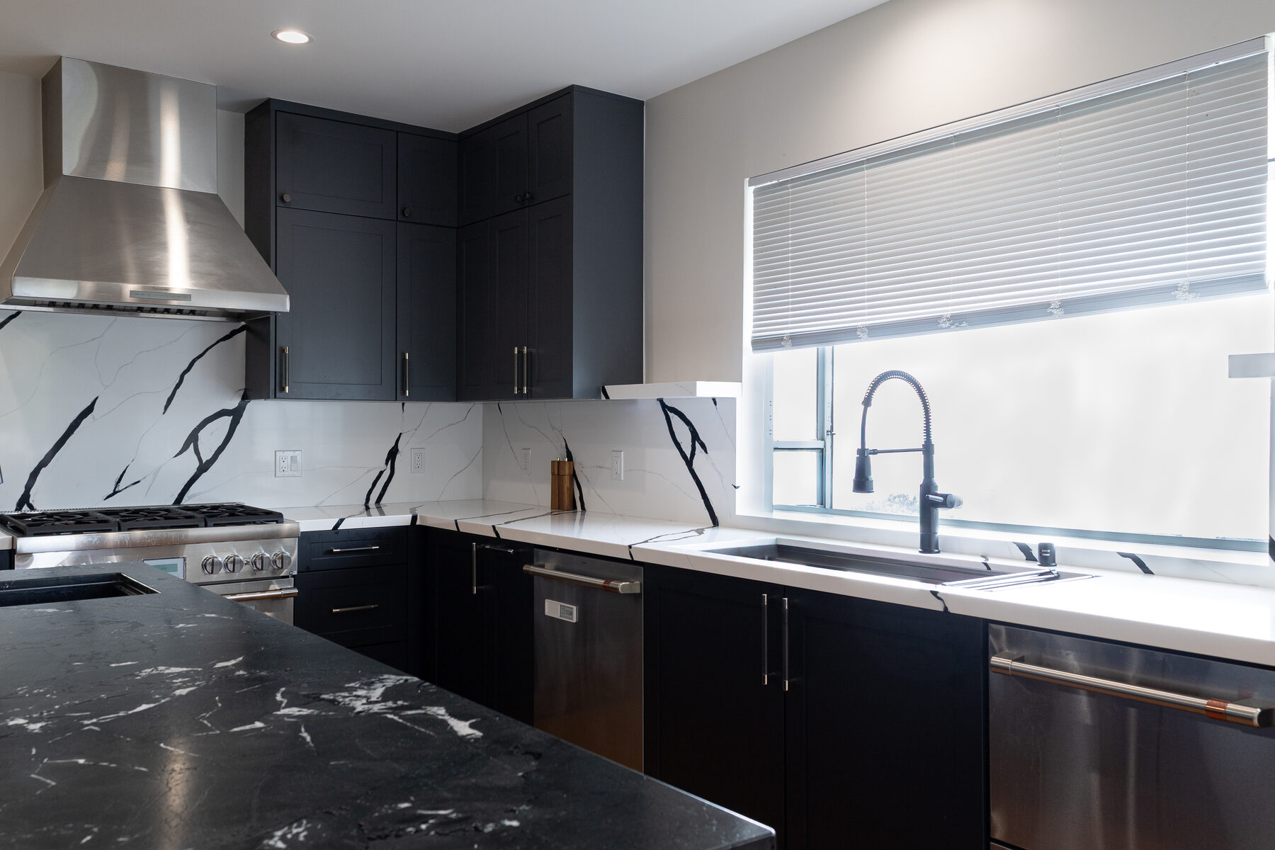 Campus Drive navy kitchen with marble range backsplash