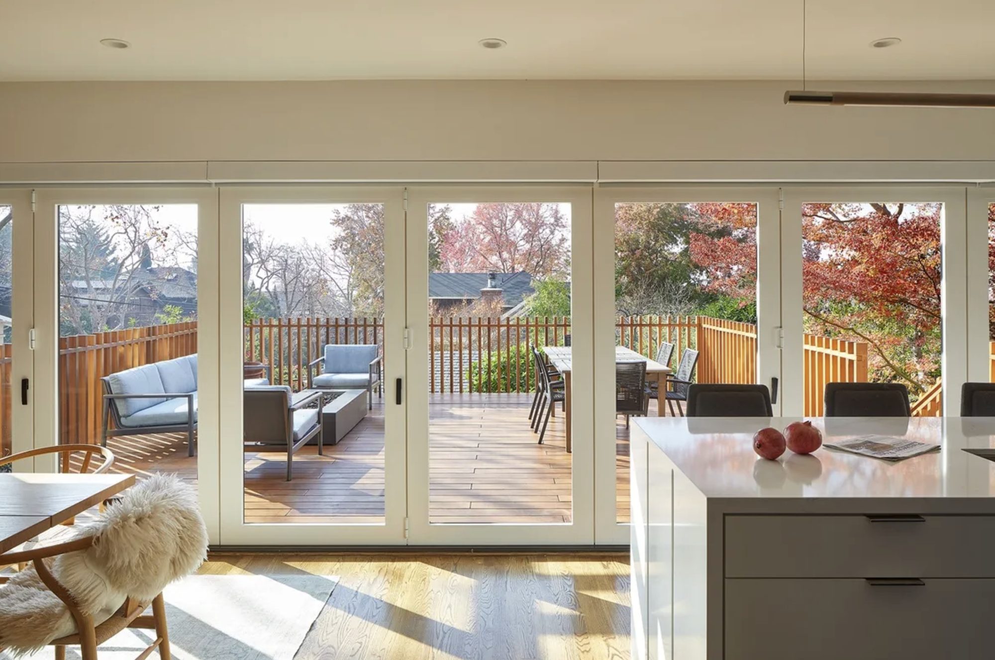 Living area with full wall of folding glass doors to the deck