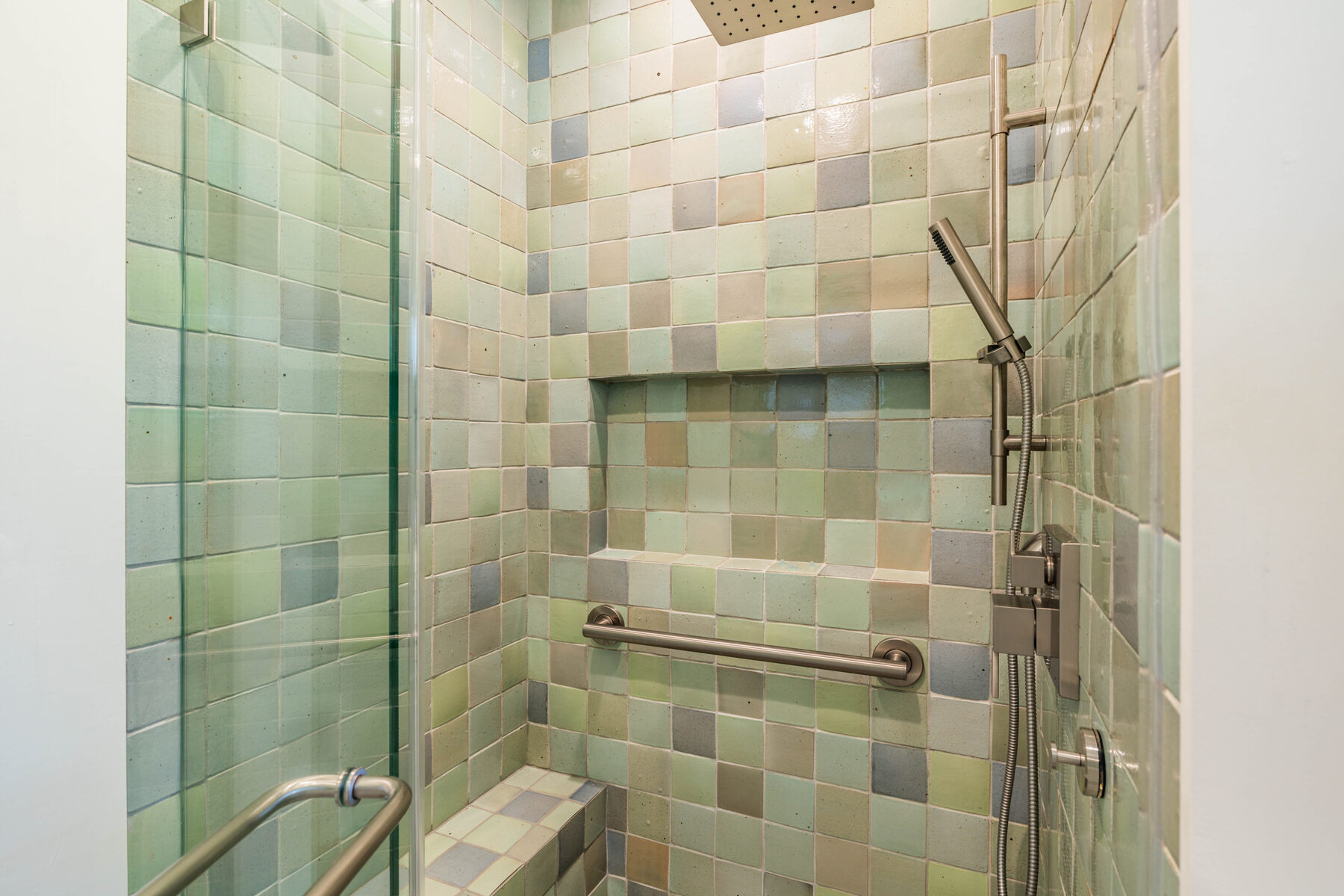 Shower niche detail with hand-glazed mosaic tile