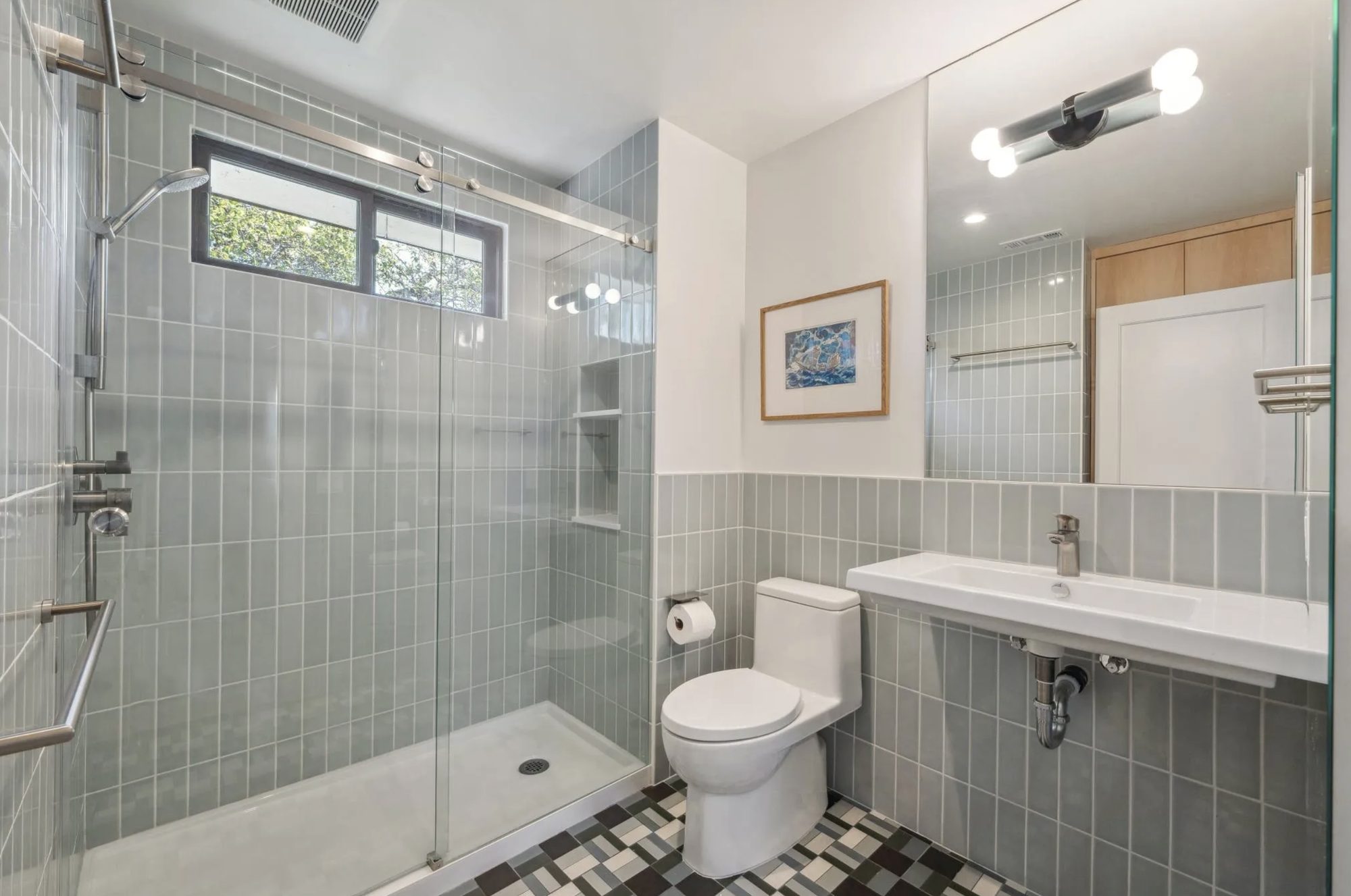 Guest bath with sage stacked tile and checkerboard mosaic floor