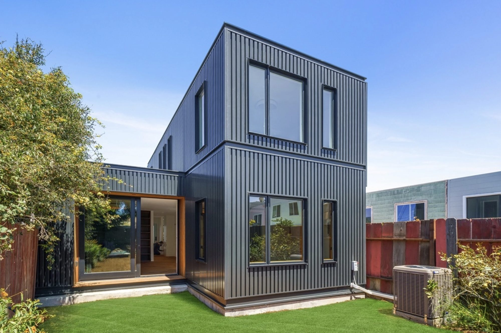 Magnolia Street modern metal-clad rear addition opening to the garden