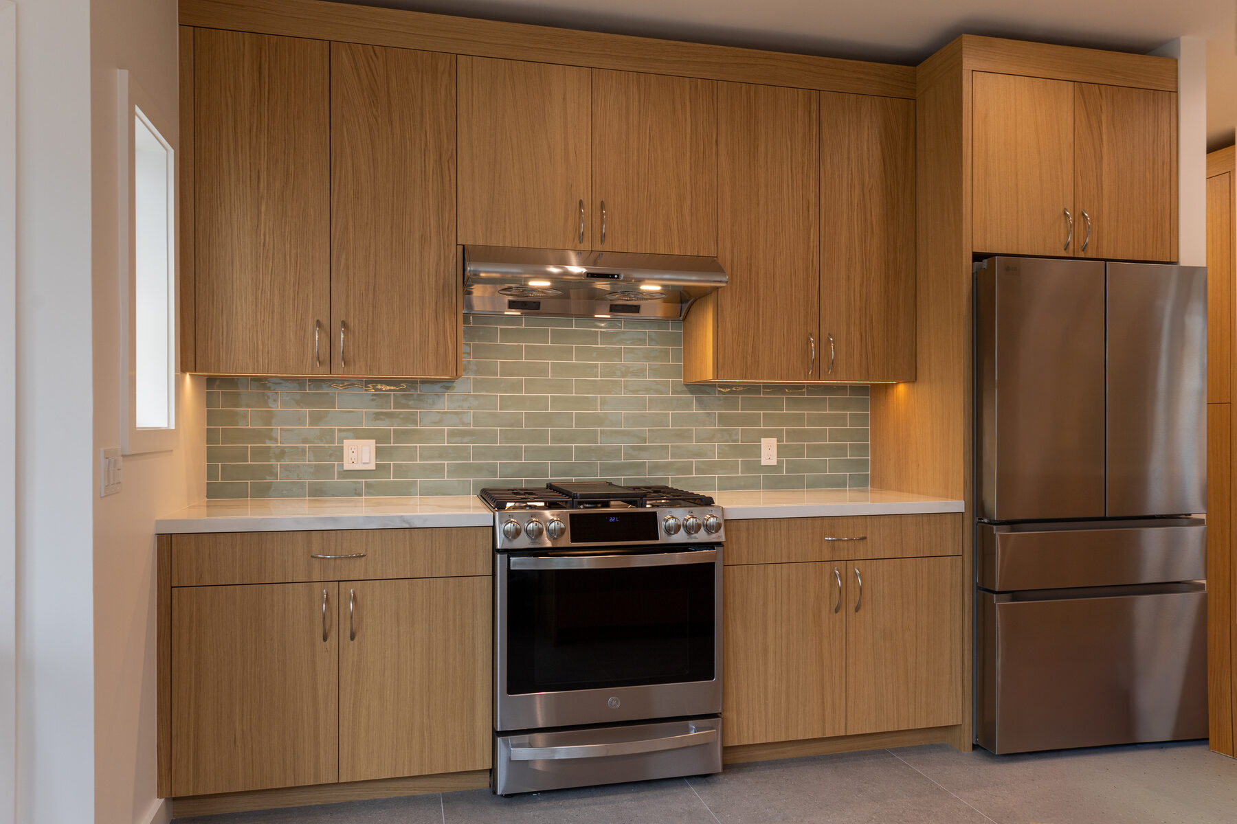 Range detail with brass fittings and hand-finished cabinetry