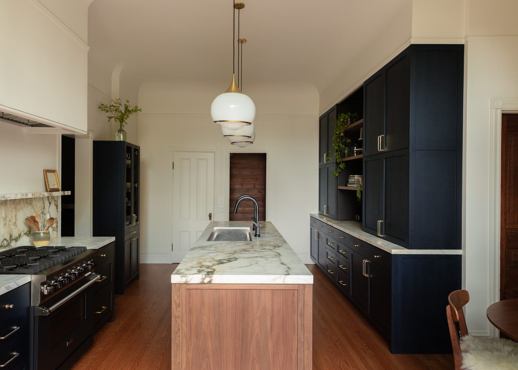 Morton Street Residence navy galley kitchen with walnut island