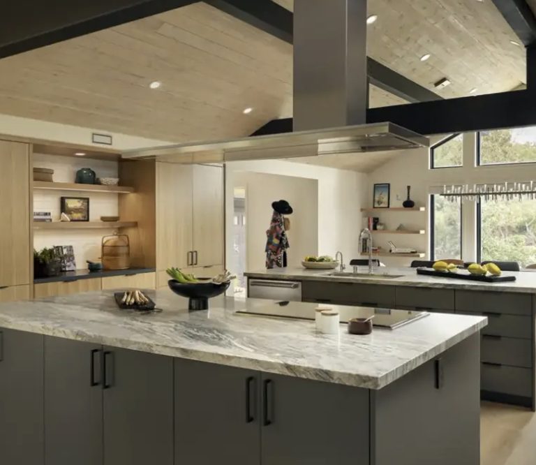 Kitchen with book-matched stone island and gable window