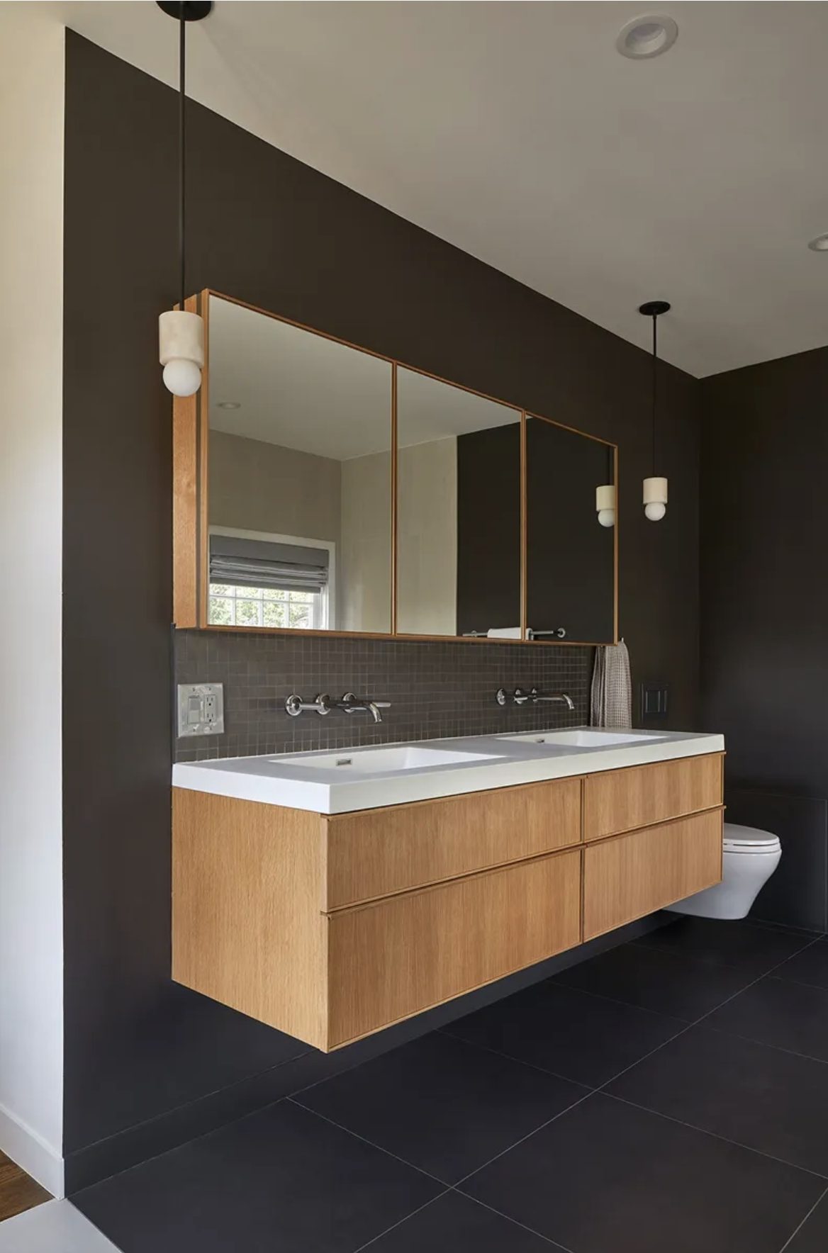 Primary bath with charcoal walls and white-oak floating vanity