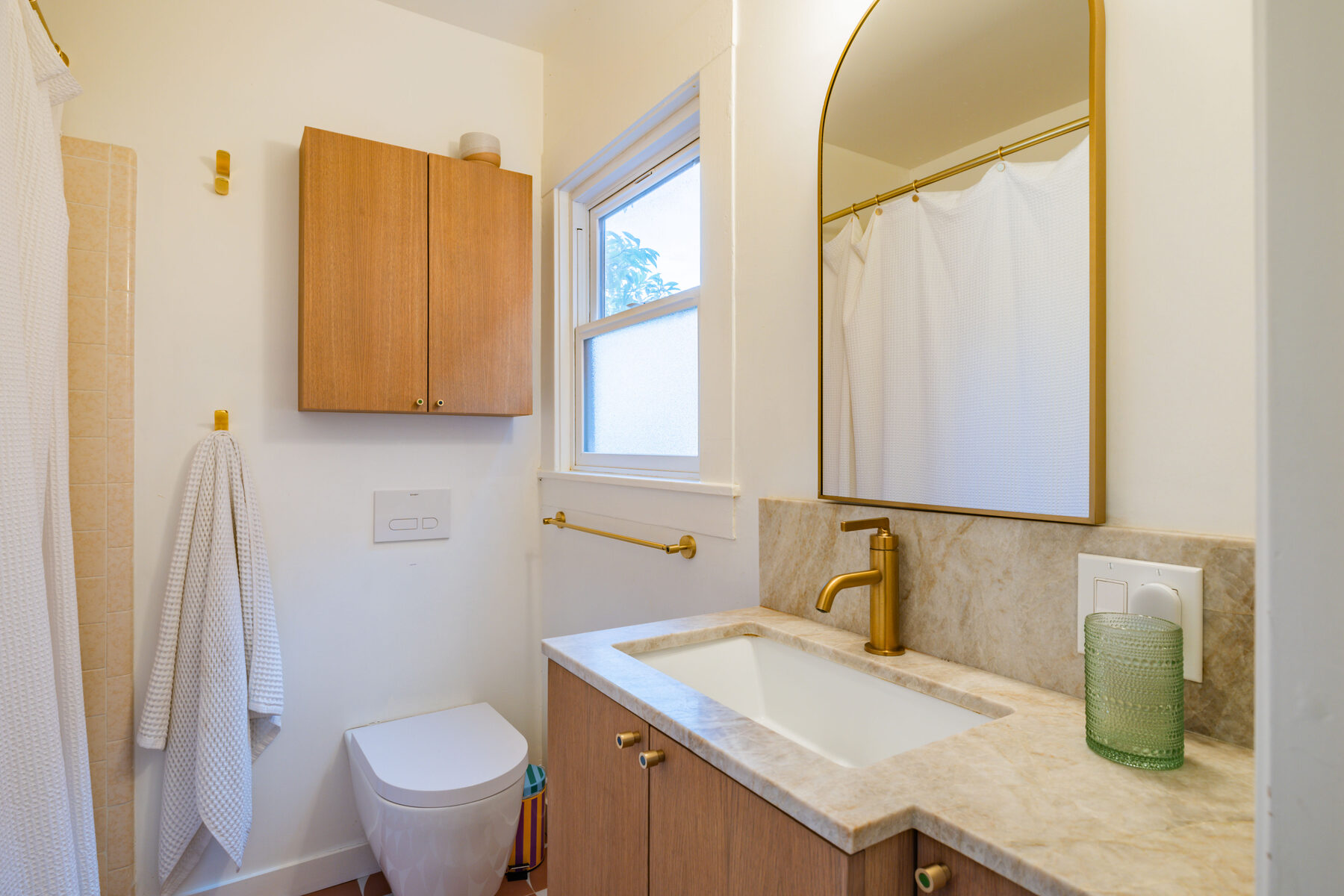 Santa Fe Avenue bath vanity with brass and quartzite