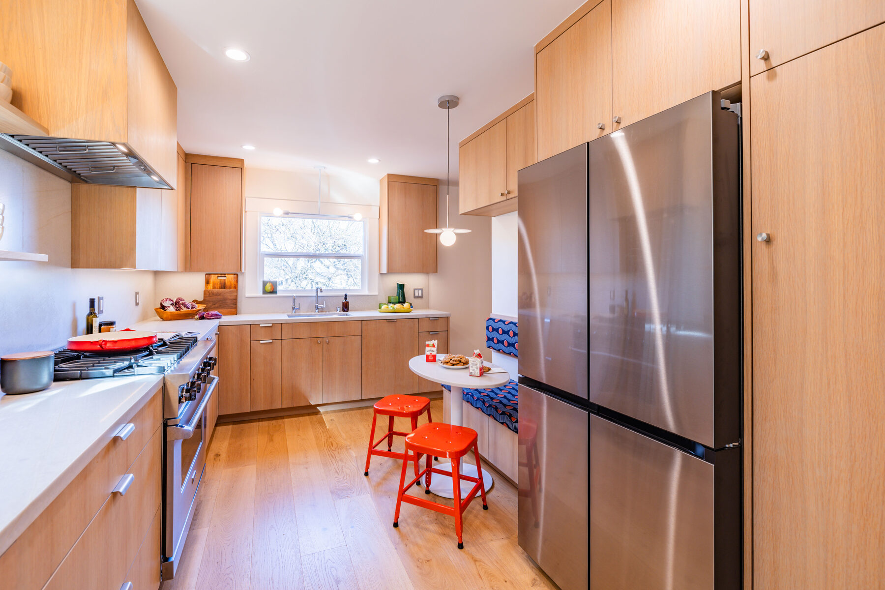Kitchen galley view to breakfast nook with red stools